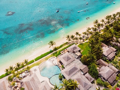 Luxury beach resort in Thailand with palms and blue ocean