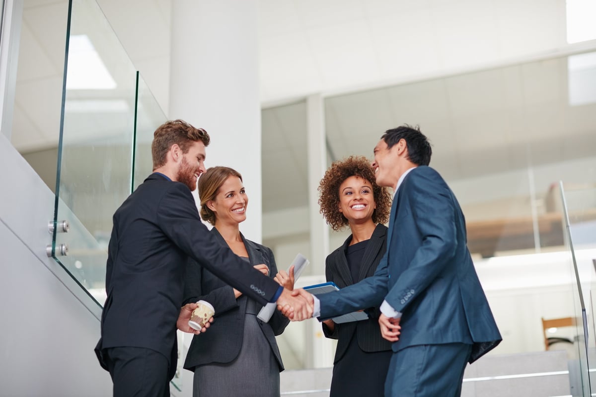 Business partners shaking hands in a modern office
