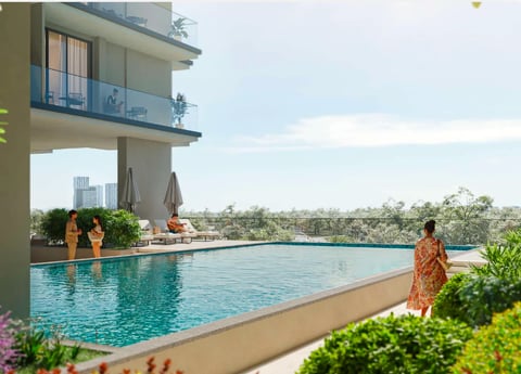 Modern rooftop infinity pool with people relaxing, high-rise building, lush greenery, and cityscape view in background