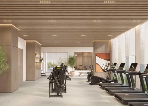 Modern gym interior with treadmills, exercise bikes, natural lighting, and minimalist wood and white design