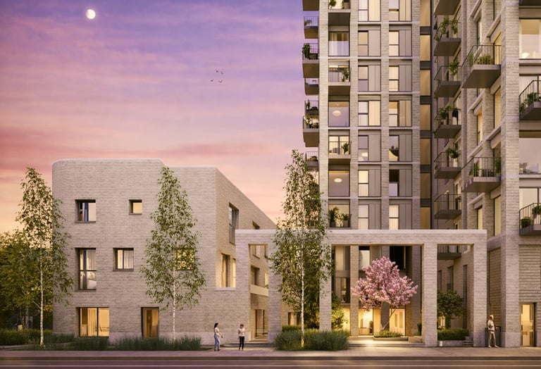 Modern residential buildings at dusk with illuminated facades, landscaping, and purple twilight sky