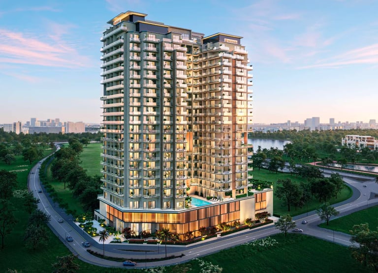 Modern high-rise residential building with illuminated facade at dusk, surrounded by green landscape and water view in urban setting.