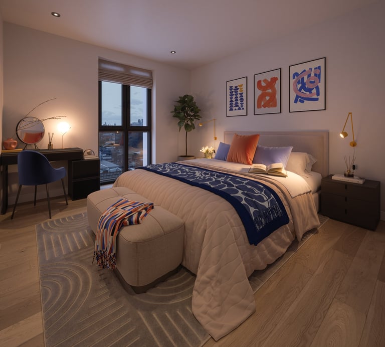 Modern bedroom with queen bed, navy blue bedding, accent pillows, geometric rug, desk area, wall art, and balcony doors at dusk
