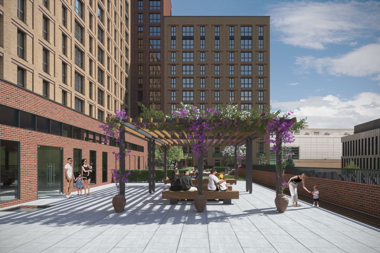 Urban plaza with flowering pergola, seating areas, and historic brick buildings under blue sky